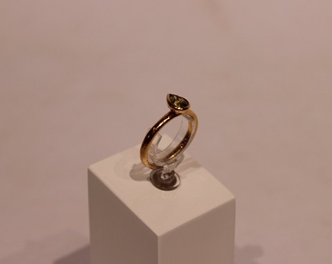 Gilded 925 sterling silver ring with green drop shaped stone by Christina 
Jewelry.
5000m2 showroom.
