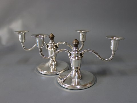 A pair of two-armed  candlesticks in hallmarked silver an decorated with Ebony, 
stamped SJ.
5000m2 showroom.