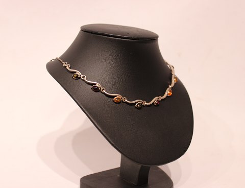 Short necklace of silver with different colored pieces of amber.
5000m2 showroom.