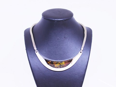 Necklace of silver with large pendant of silver and amber.
5000m2 showroom.
