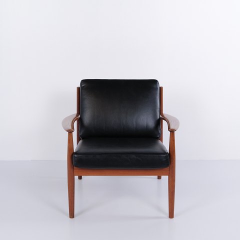 Armchair by Grete Jalk for France & Søn in teak and black leather, 1960s