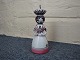 Bell in a delicate pink color,  in shape  of a woman designed by Lars Syberg. 
Height 24 cm. 5000 m2 showroom.