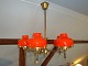 Hanging lamp in brass with red domes from Holmegård 5000 m2 showroom
