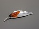 Brooch shaped as a leaf with a piece opf amber stamped Original Ulrich in 925 
sterling silver.
5000m2 showroom.