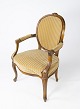 Rokoko armstol af lyst træ og polsteret med lyst velour stof fra 1920erne. 
5000m2 udstilling.